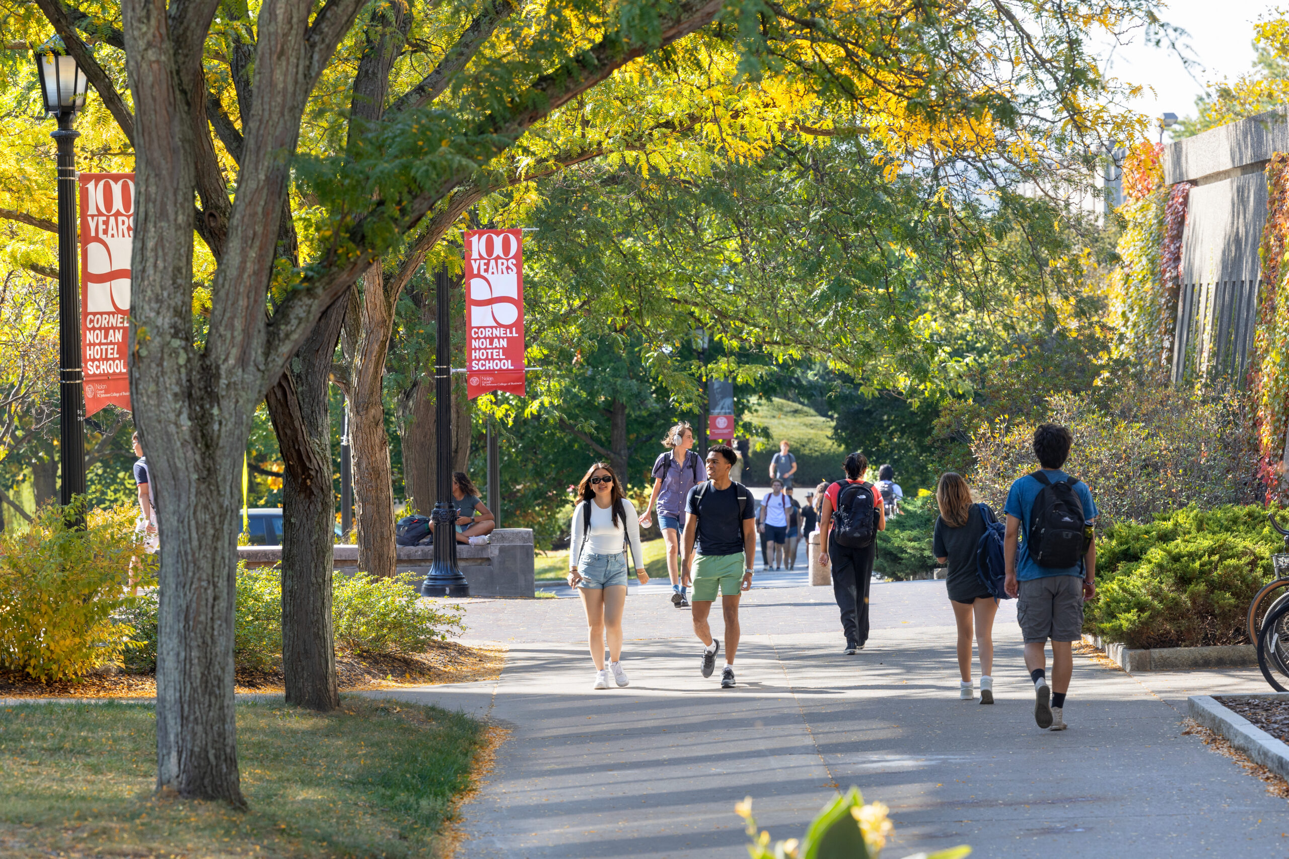 Students walk past Peter Plaza on a warm fall day