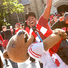 The Big Red Bear playfully lifts a student in the air during Homecoming 2011