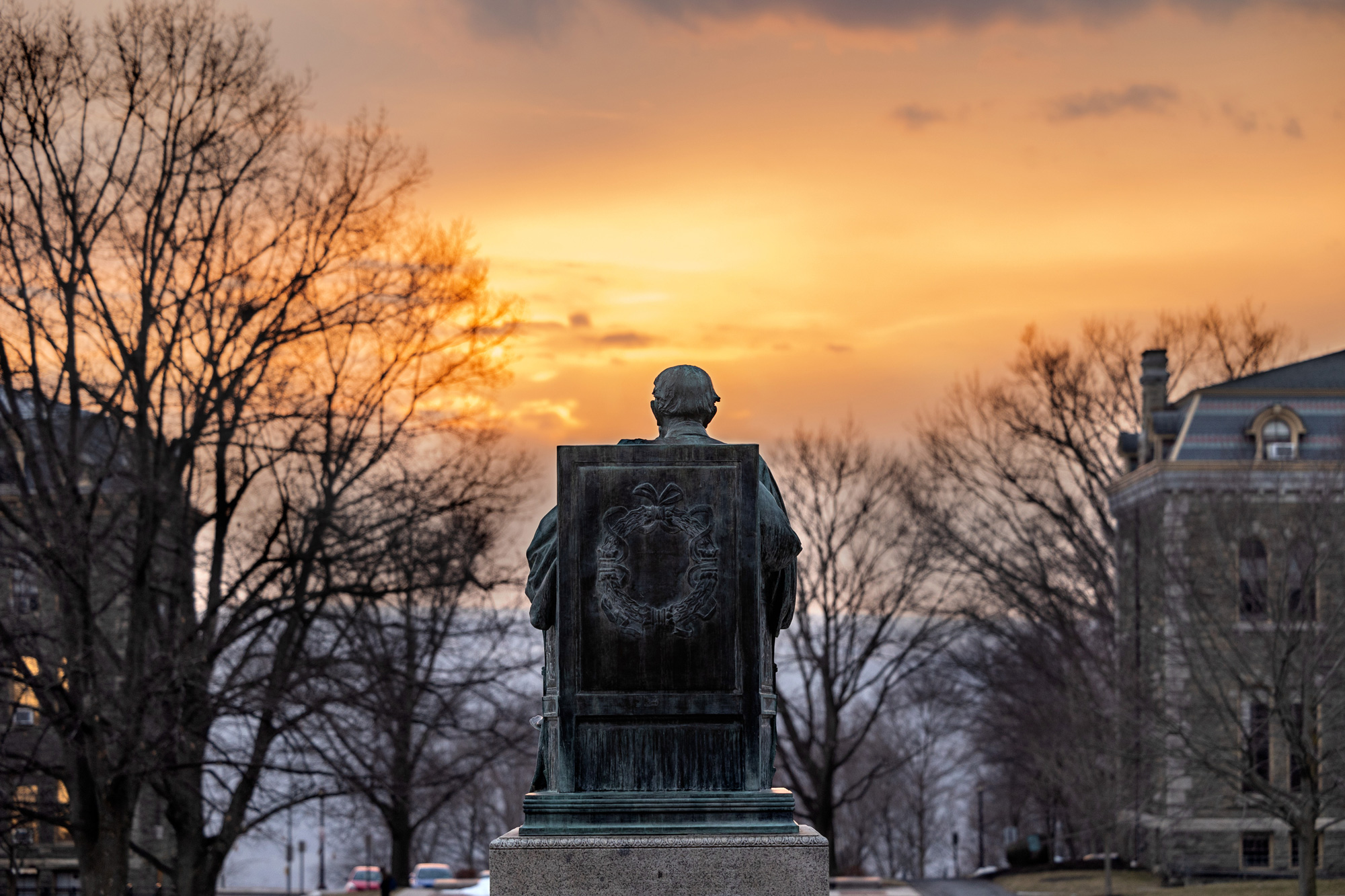 A.D. White statue looks across the Arts Quad at sundown